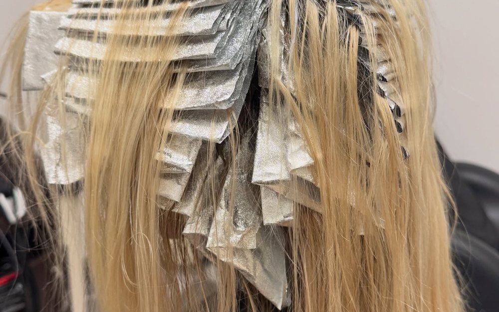 Packed-in foils mid-blonding session on long blonde hair at Beauty by Kayla Mac in Auburn, CA.